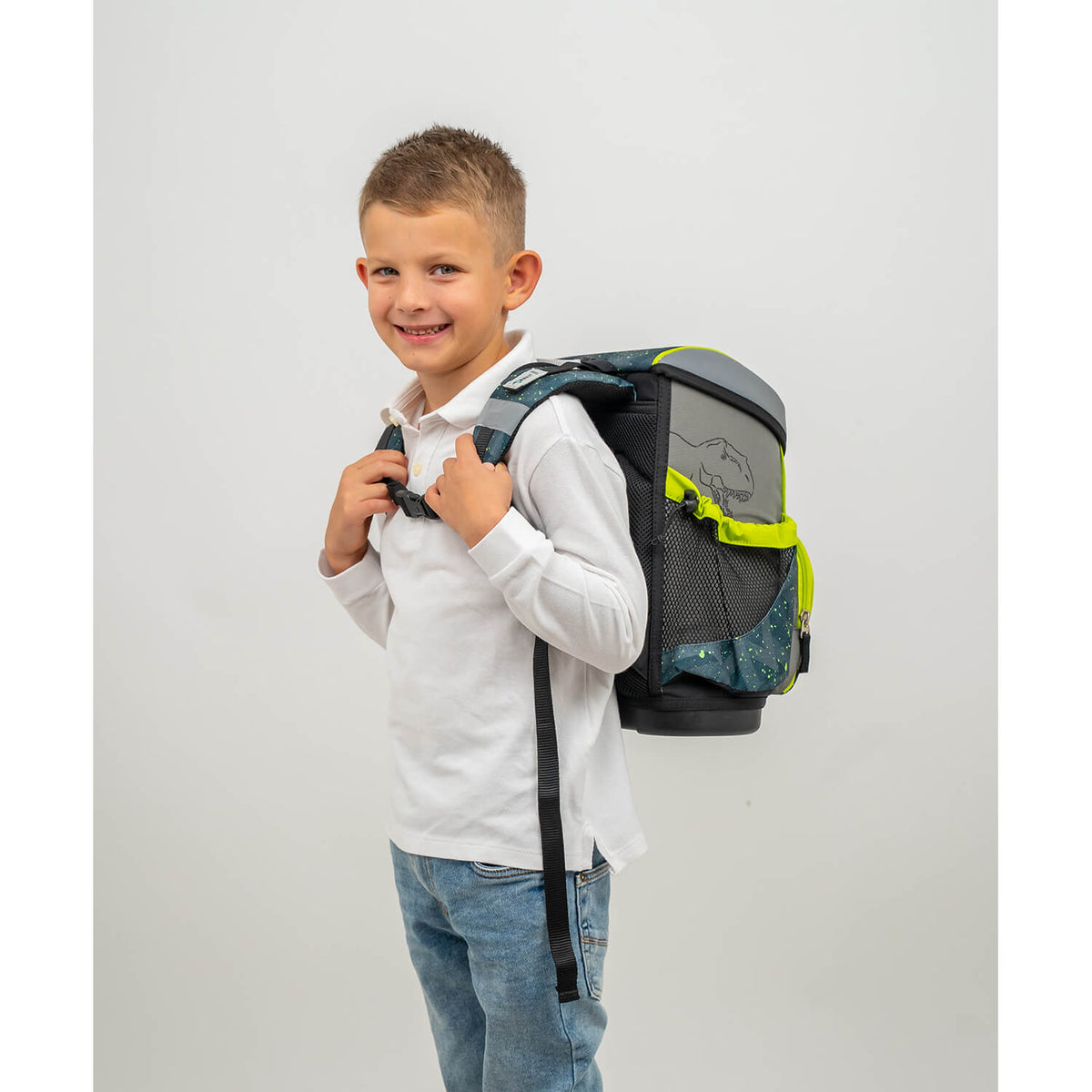 A boy wearing the Belmil Mini-Fit T-rex Roar schoolbag, smiling while showcasing the ergonomic design - Ergonomic School Bag Set for Boys – Belmil Mini-Fit T-rex Roar (4 pcs).