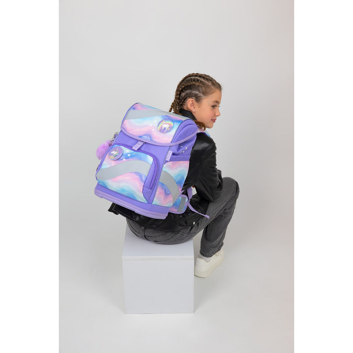 The Belmil Smarty Rainbow Land Ergonomic School Bag Set – 5-Piece Set with 9 Interchangeable Patches and Hip Belt displayed at an angle, highlighting its practical features.